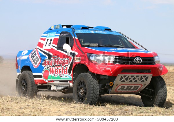 Sun City, South\
Africa - OCTOBER 1, 2016: Forty Five degree close-up view of\
Speeding red and blue Toyota Hilux twin cab rally car in race at\
Sun City 450 Rally Racing\
event