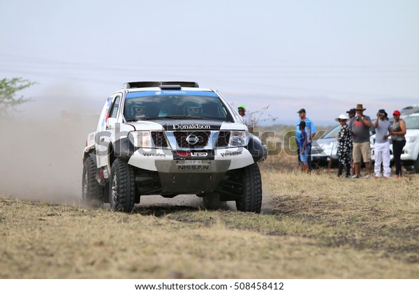 Sun City, South\
Africa -OCTOBER 1, 2016: Front view of Speeding black and white\
Nissan Navara  rally car in race at Sun City 450 Rally Racing\
event, Sun City, South Africa \
