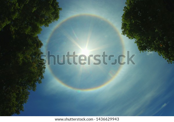 sun
corona rainbow clouds and blue sky background

