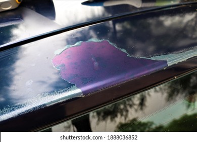 Sun Damage Seen On The Roof Of A Vehicle .This Has Caused The Clear Coat Of Paint To Peel Off From The Body Of The Car.