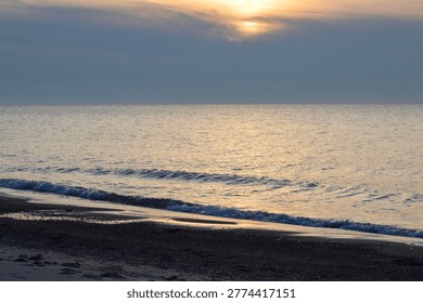 sun dipping behind the clouds