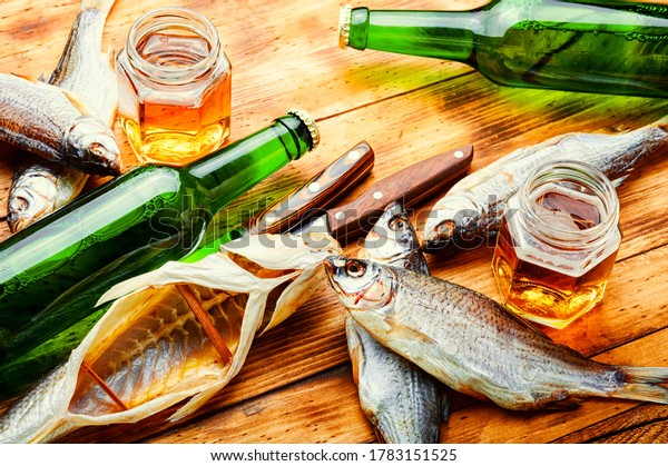 Sun dried fish,salted fish.Salty fish or\
stockfish.Glass of beer and dried\
fish