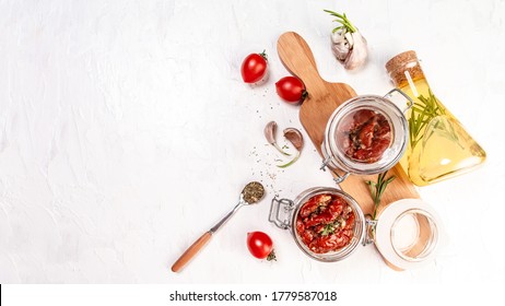 Sun dried tomatoes with fresh herbs and spices. Delicious snack on wooden textured background, top view. space for text. Long banner format. - Shutterstock ID 1779587018