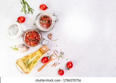 Sun dried tomatoes with garlic, oregano, olive oil in a jar on a light table, banner, menu recipe place for text, top view. - Shutterstock ID 1786370756