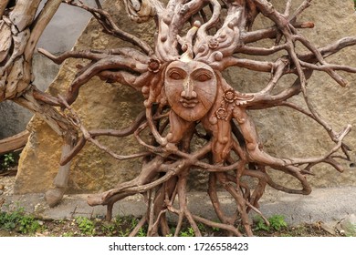 Sun with face made of tree root. Wooden decoration. Dried fibrou