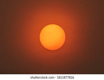 Sun Filter Through Smoky Skies Of California Wildfires 2020. Smoke And Ash Particles Creating Eerie Sun Glow In San Francisco Bay Area.