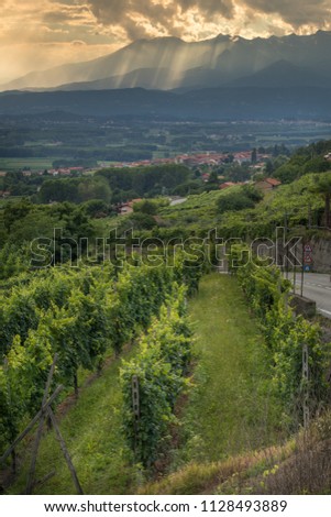 Sun filtering through the clouds over the Canavese Mountains in Piedmont Italy