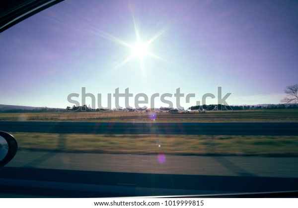 Sun flare on a\
window car view landscape