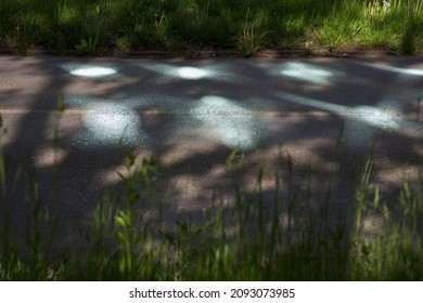 Sun Glare On The Pavement. Sun Glare On The Road. Bright Glare From Glass . Light On The Road.