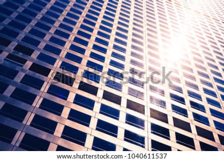 sun glow between the windows of the skyscraper