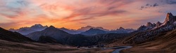 Sun Glow And Lust Sunlight In Evening Hazy Sky. Italian Dolomites Mountain Panoramic Peaceful View From Giau Pass. Climate, Environment And Travel Concept Scene.