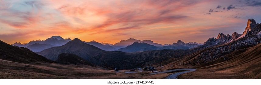 Sun glow and lust sunlight in evening hazy sky. Italian Dolomites mountain panoramic peaceful view from Giau Pass. Climate, environment and travel concept scene. - Powered by Shutterstock