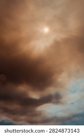 Sun glowing through a dense orange and brown smoke cloud caused by a massive forest wildfire in Deliblatska Pescara nature reserve. Deliblato, Serbia - August 7, 2026.