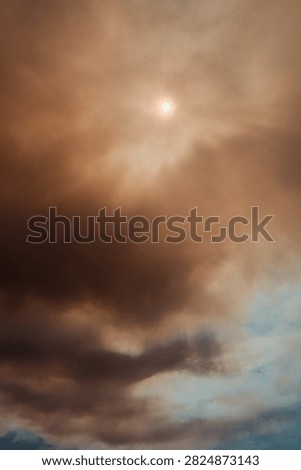 Sun glowing through a dense orange and brown smoke cloud caused by a massive forest wildfire in Deliblatska Pescara nature reserve. Deliblato, Serbia - August 7, 2026.