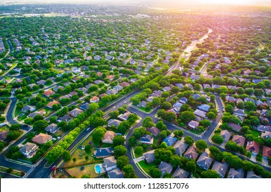 Sun Glows Sunset Real Estate Suburb Homes. Community Suburbia Neighborhood In North Austin In Suburb Round Rock , Texas Aerial Drone View Above New Development