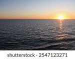 The sun goes down on a summer evening over the Kattegat Sea between Denmark and Sweden. Seen from a ferry northbound to Frederikshavn and Oslo.