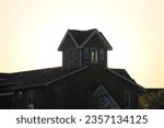 Sun going down behind a lakefront building