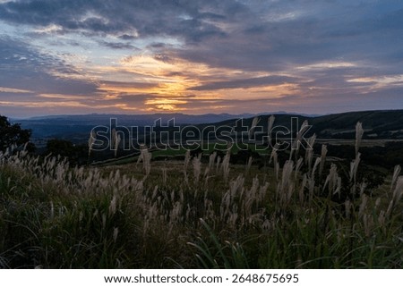 sun is going down behind the mountain in plateau of Kumamoto prefecture, JAPAN.