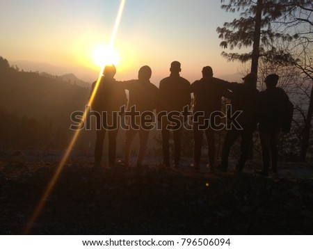 Sun is going down slowly as 6 friends altogether are watching this sunset