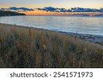 The sun has just broke the horizon over Newport Bay in Lake Michigan, at Newport State Park, Door County, Wisconsin