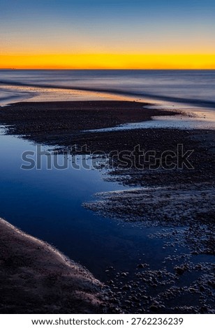 The sun has set below the Lake Superior horizon at the mouth of the Hurricane River, Pictured Rocks National Lakeshore, Alger County, Michigan