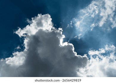 Sun hidden behind a dramatic cloud with backlit edges and sunbeams