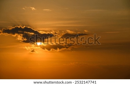 Similar – Image, Stock Photo Evening sun hidden behind clouds. Golden glow over the water.