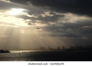 Sun hides behind the clouds. Rays are visible.