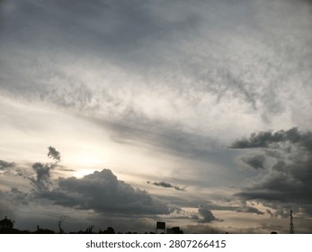 The sun hiding behind the clouds