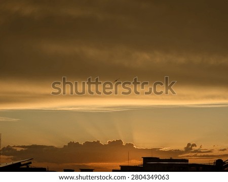 Sun hiding behind clouds  during sunset