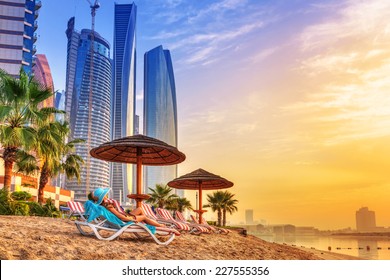 Sun holidays on the beach of Persian Gulf at sunrise