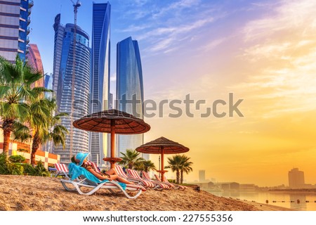 Sun holidays on the beach of Persian Gulf at sunrise