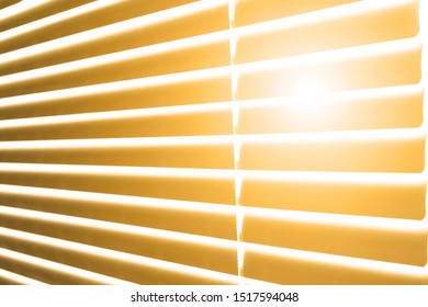 sun illuminates room or office through gap on wooden venetian blinds on hot sunny day - Powered by Shutterstock