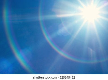 Sun With Lens Flare, On Blue Sky Background.