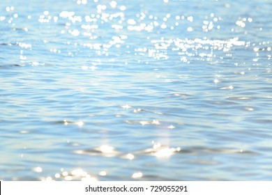 Sun light reflecting or sparkling glitter on water of sea or ocean with beautiful sky blue light tone. - Shutterstock ID 729055291
