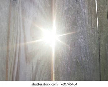 Sun Light Shining Through Crack In Wood Fence