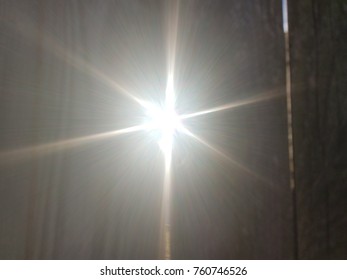 Sun Light Shining Through Crack In Wood Fence