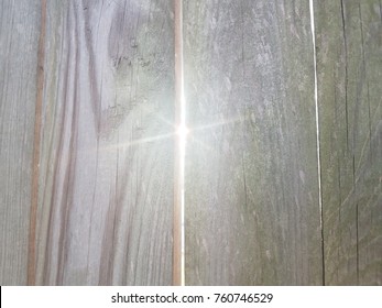 Sun Light Shining Through Crack In Wood Fence