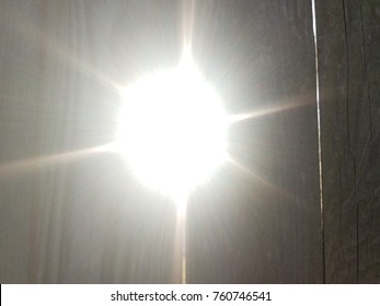 Sun Light Shining Through Crack In Wood Fence