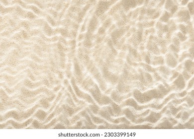 sun lights shadow in wavy water on abstract sand background, beautiful abstract spa concept banner of sea paradise island
