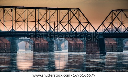The sun lights up the underside of a series of bridges over the Susquehanna River in Harrisburg, Pennsylvania in winter