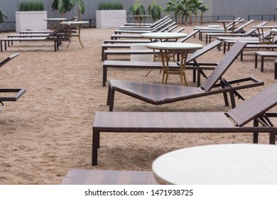 Sun Loungers On The Beach. Broken Deck Chair