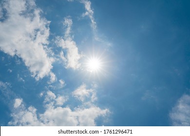 The sun in the navy blue heaven in the summer sunny day. Clouds and sun in the sky copy space - Shutterstock ID 1761296471
