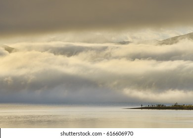 Sun On Fog With Lighthouse On Cape