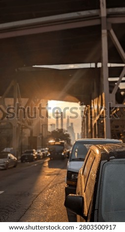 Sun peaking though buildings after a storm. 