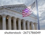The sun peaks through clouds to stream through American Flag outside of the United States Supreme Court