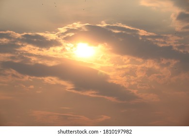 Sun peeping through clouds at sunset