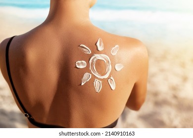 Sun Protection.Sun Cream. Woman Applying Sun Cream on Tanned  Shoulder In Form Of The Sun. Skin and Body Care. Girl Using Sunscreen to Skin.  - Shutterstock ID 2140910163