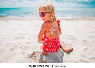 Sun Protection- Happy Little Girl With Suncream At Beach