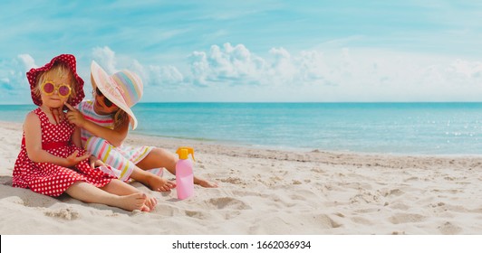 Sun Protection- Little Girls With Suncream On Beach